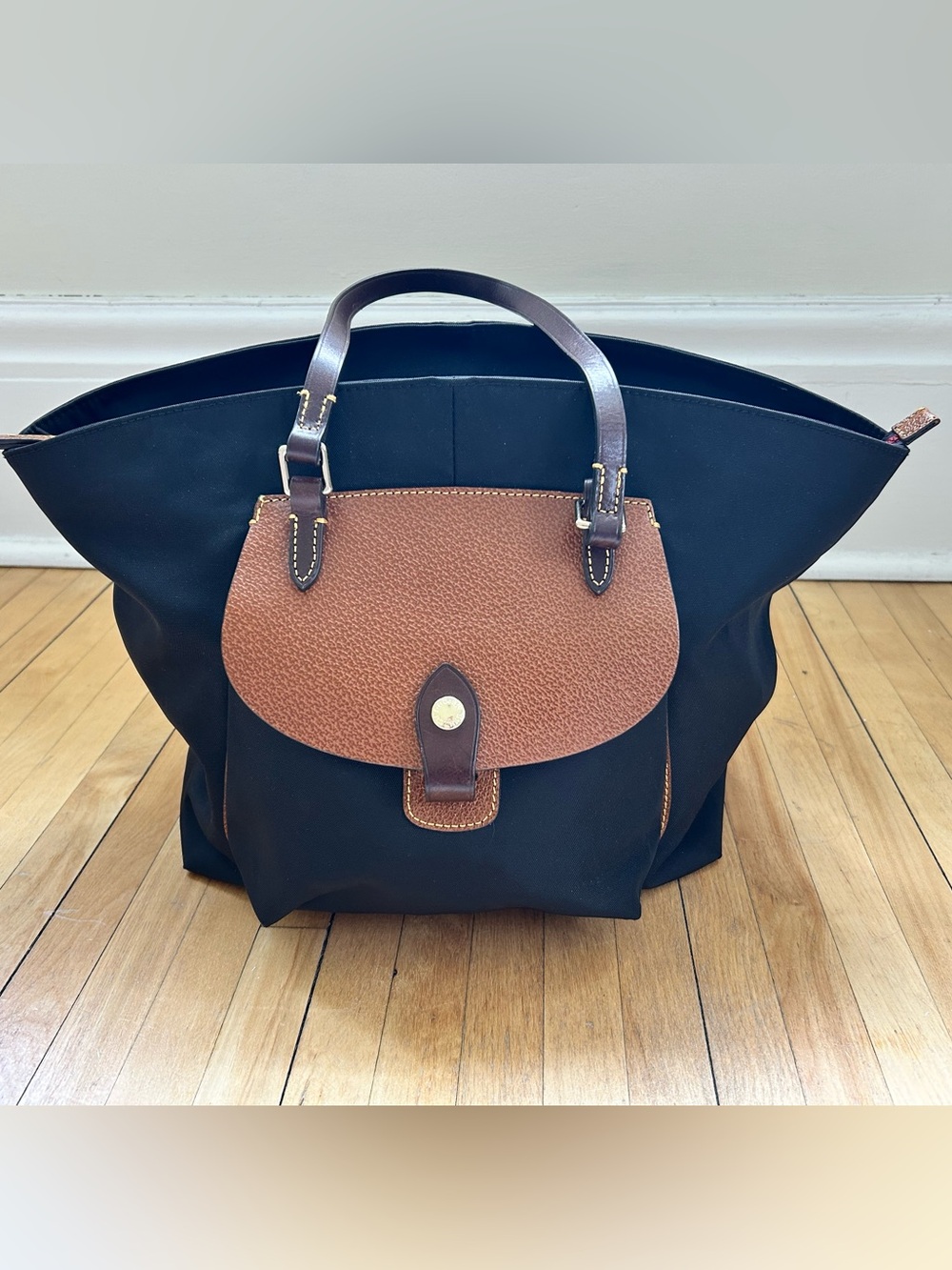Dooney & Bourke Black Tote with Leather Pockets and Red Interior